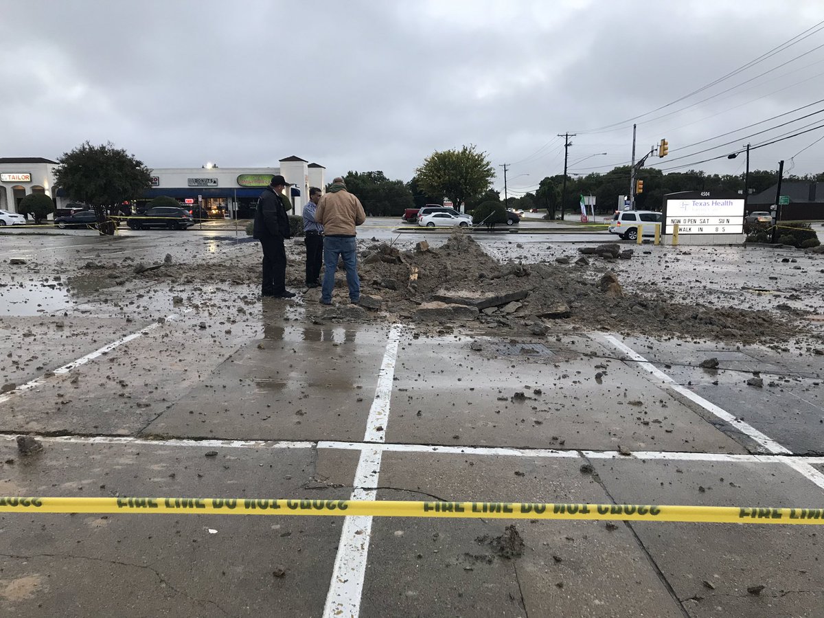 A lightning strike in this north Fort Worth parking lot makes a large hole and sends debris flying through the air. No injuries reported.