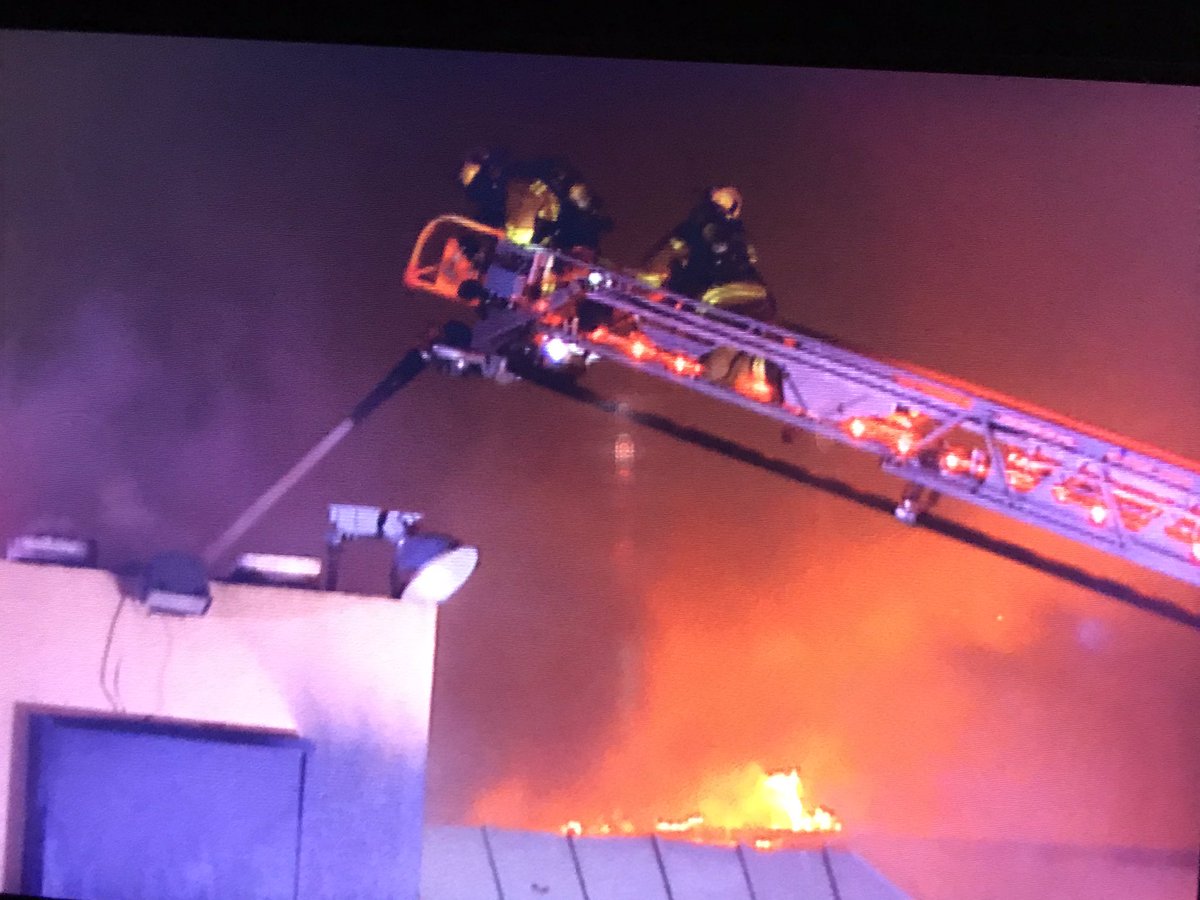 Dallas Fire Rescue on scene Composite near I-35 in NW Dallas working a large structure fire. Firefighters continue to battle this 2 Alarm blaze from all sides