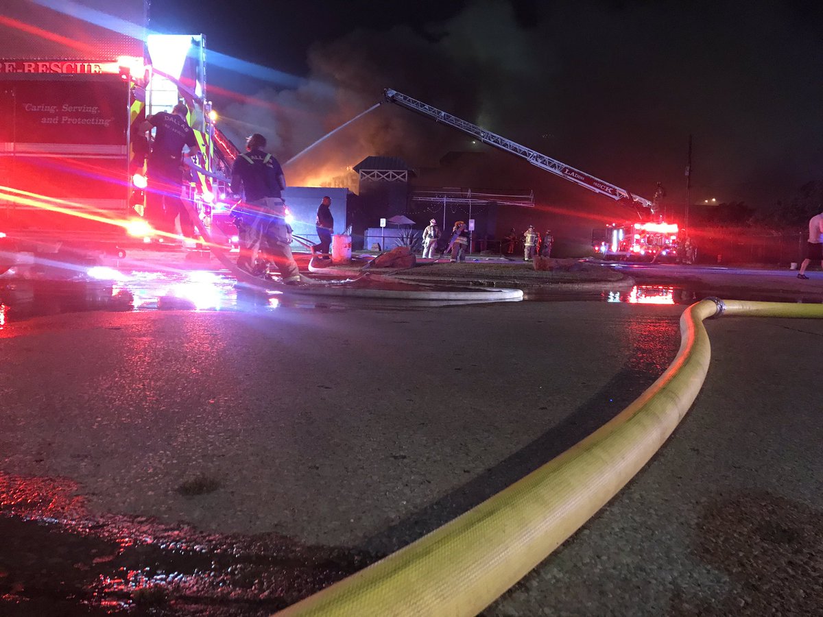 Dallas Fire Rescue on scene Composite near I-35 in NW Dallas working a large structure fire. Firefighters continue to battle this 2 Alarm blaze from all sides