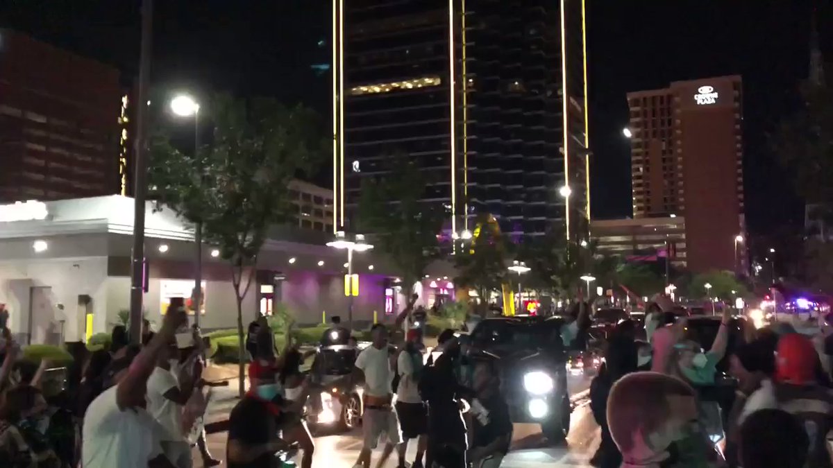 Rioters cheer as they take over the streets of Dallas and traffic honks in solidarity