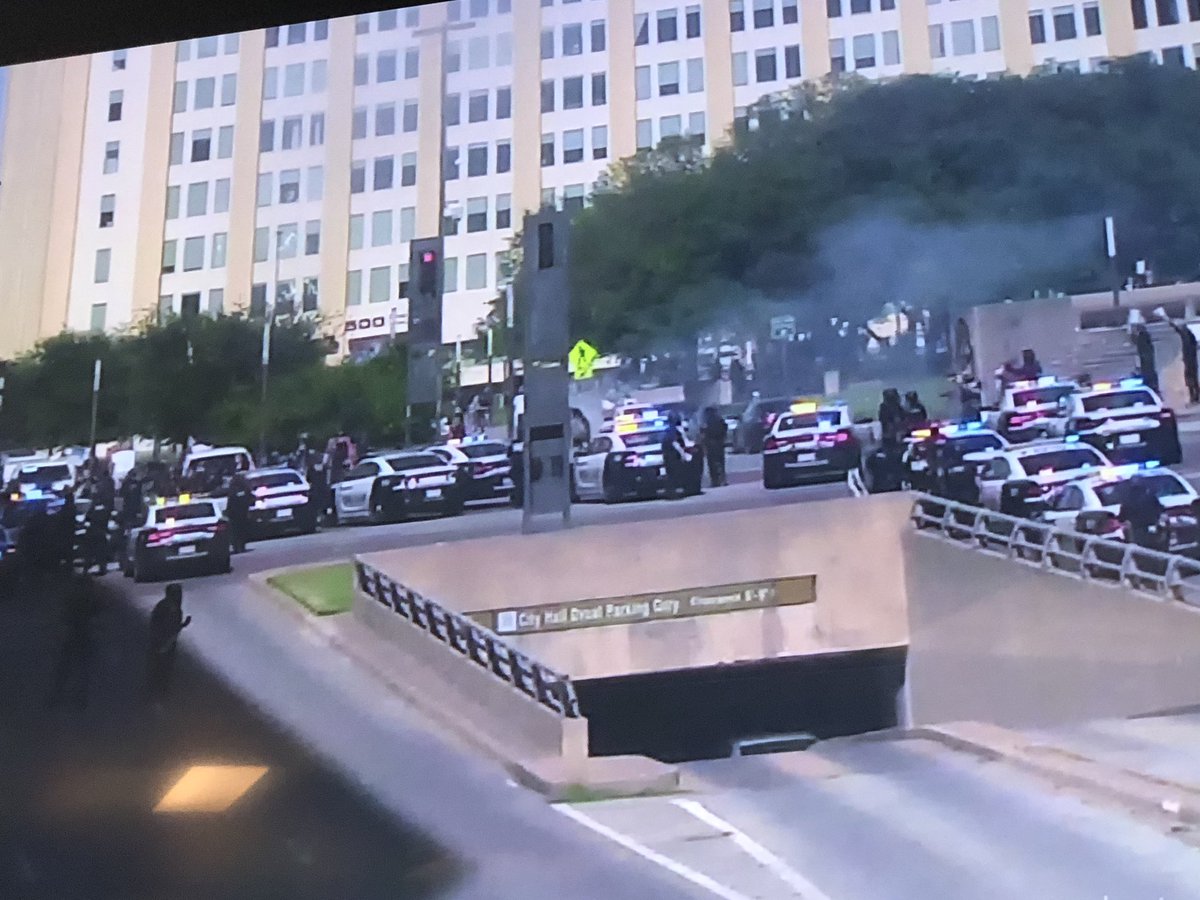 Dallas Police Dept:Dallas SWAT deployed gas to disperse the unruly protesters at the corner of Young and Akard Street. @ChiefHallDPD @CityOfDallas
