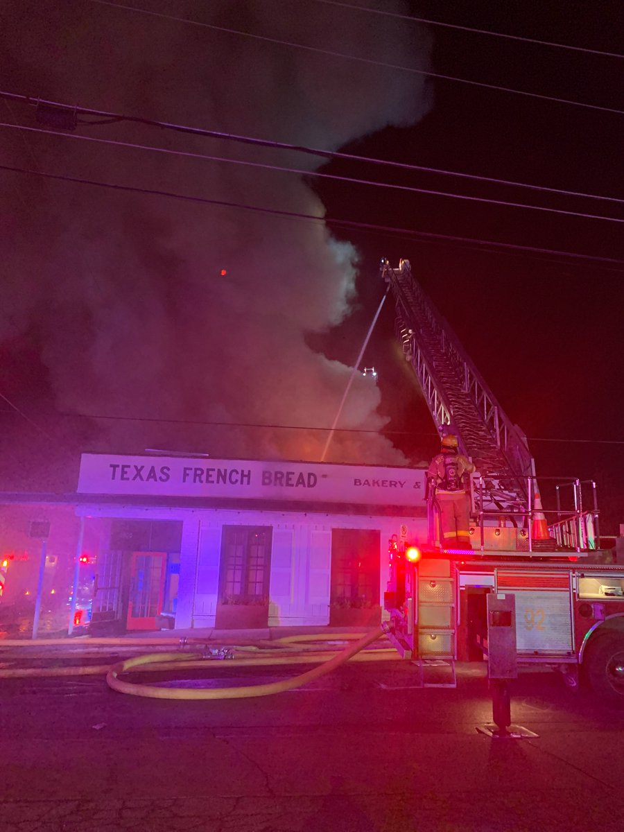 Crews operating at a structure fire at 2900 Rio Grande (Texas French Bread Bakery). Fire venting from the roof on arrival