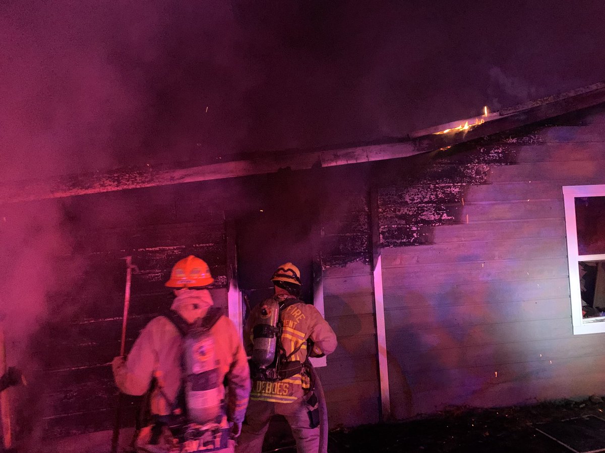 Fire in a group home 1305 Green Forest Dr. Back of house heavily involved on arrival. 6 adults will be displaced. Security video shows cause as improperly discarded smoking material