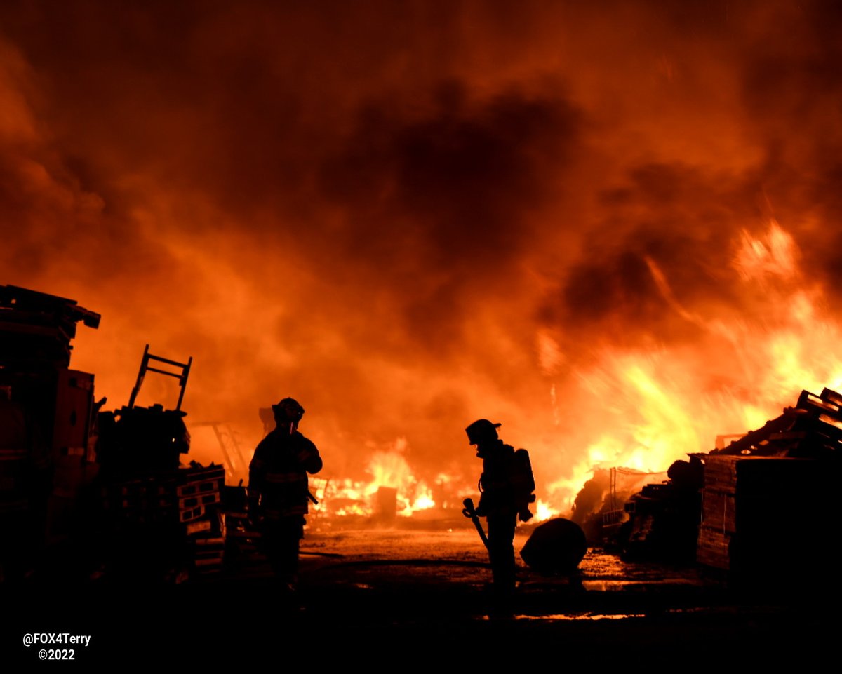 Standing their ground. As a tornado warned storm blew through Johnson Co firefighters worked to ensure a  pallet fire didn't spread into nearby homes. 