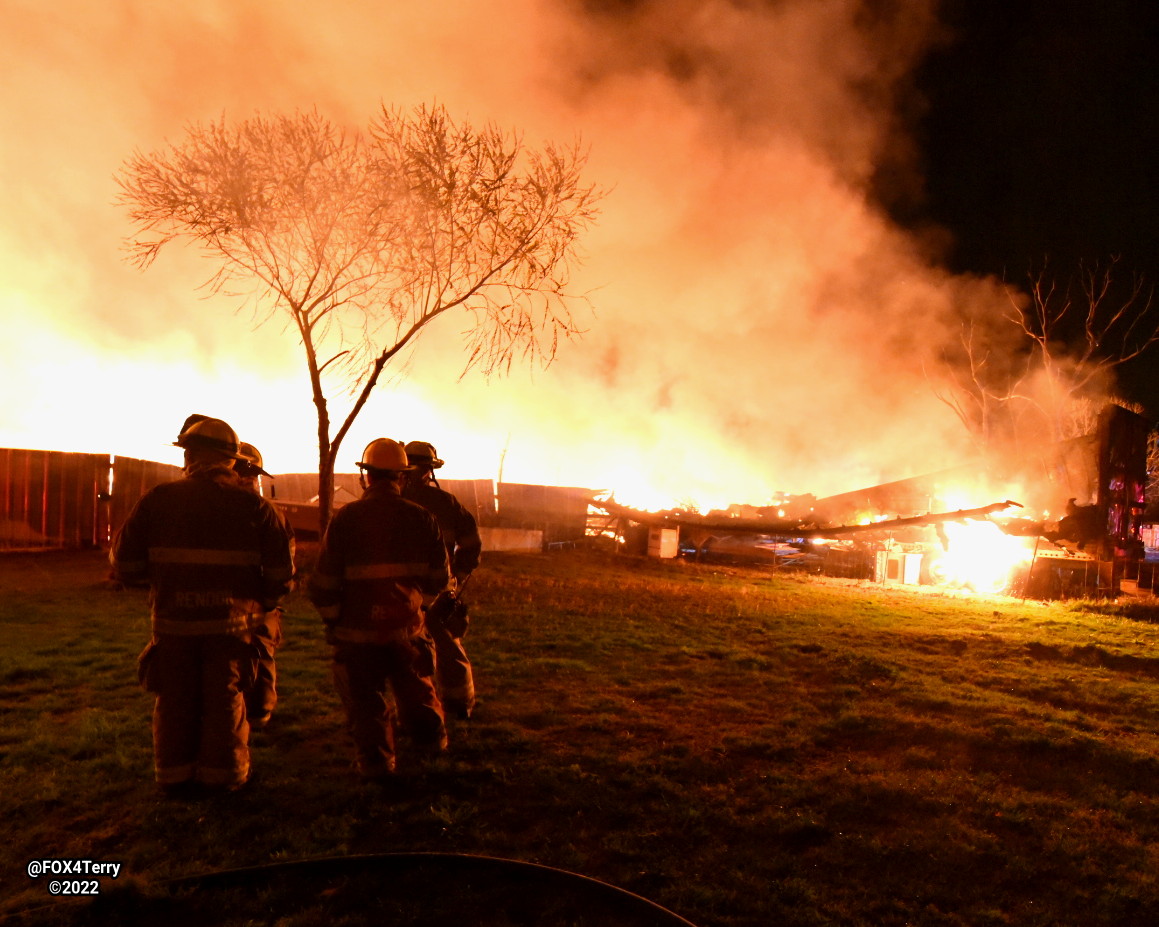 Standing their ground. As a tornado warned storm blew through Johnson Co firefighters worked to ensure a  pallet fire didn't spread into nearby homes. 