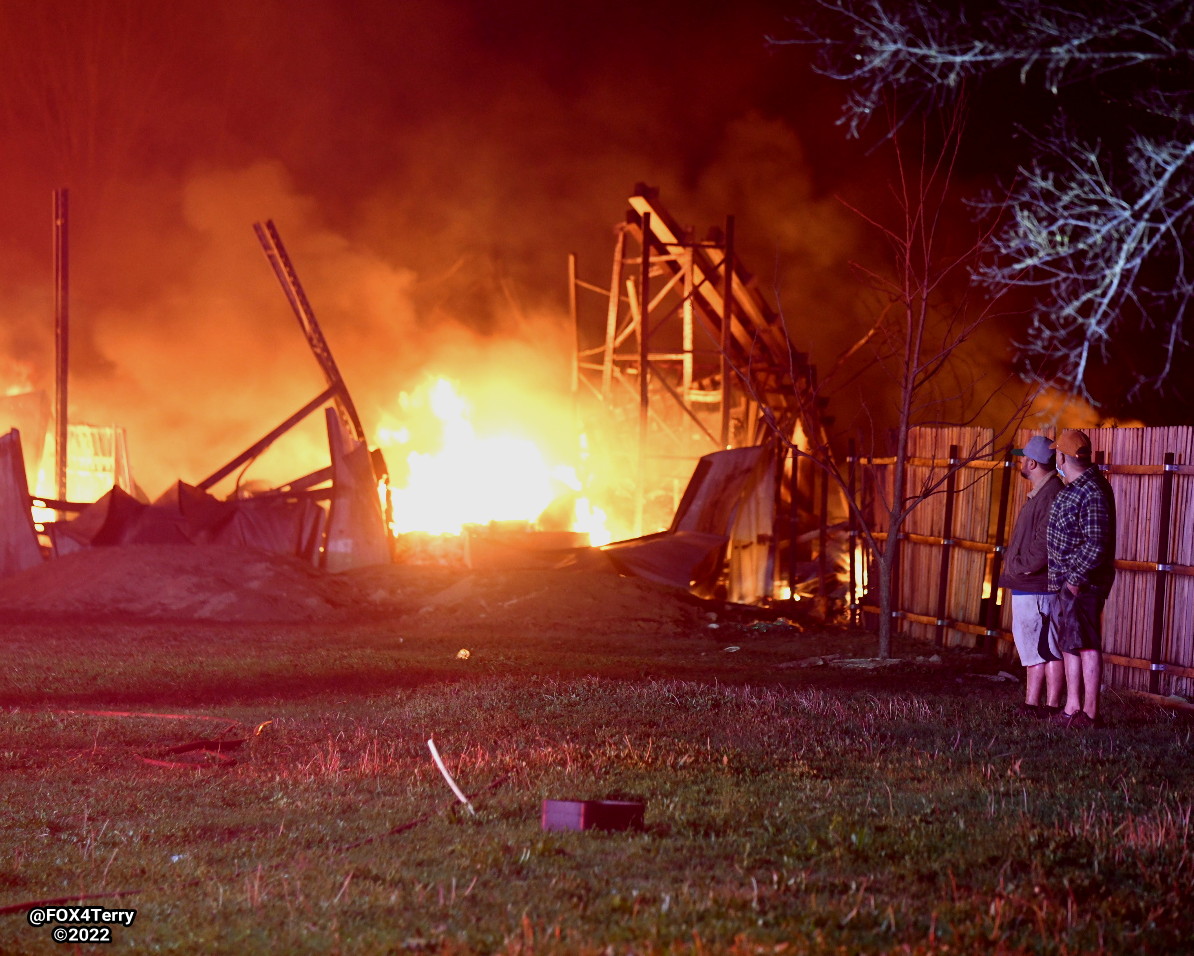 Standing their ground. As a tornado warned storm blew through Johnson Co firefighters worked to ensure a  pallet fire didn't spread into nearby homes. 