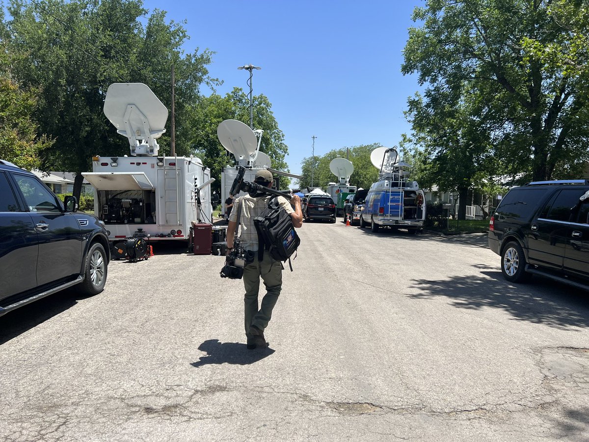 Here's how the area around Robb Elementary looks now. The school sign decorated with flowers, balloons lining a fence here. Mobile commands for law enforcement