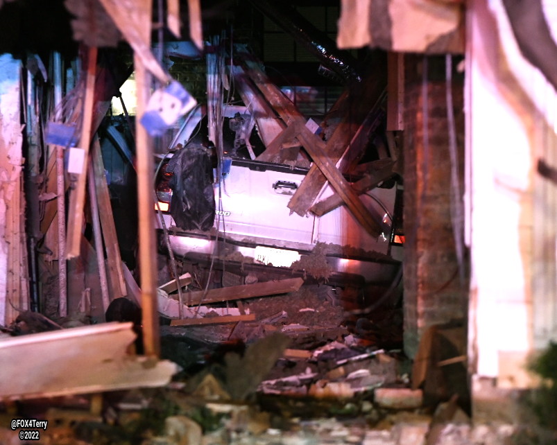 A resident inside his Bryan Place home escapes injury as a pickup drives down his hallway. The truck entered the front of the home destroying the living room, bathroom and bedroom before crashing through the rear wall. 