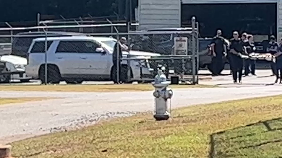 Georgia troopers carry their K9 shot multiple times and load into a GSP helicopter to fly to emergency vet.  Wounded during arrest of murder suspect from Clayton County.