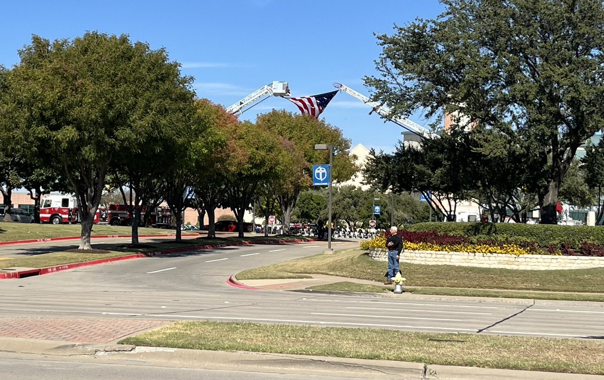 A man standing outside Prestonwood Baptist Church has been taking off his hat as officers go in for Carrollton Officer Steve Nothem's funeral