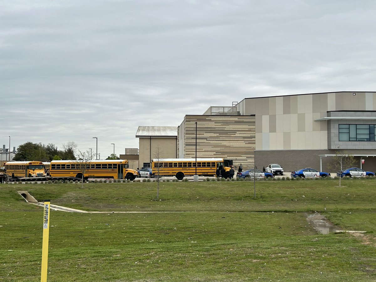 Buses arrive at Arlington ISD Athletic Complex for students to be reunited with parents after shooting outside Arlington Lamar High School. 2 students injured; shooter in custody. Happened before school day began
