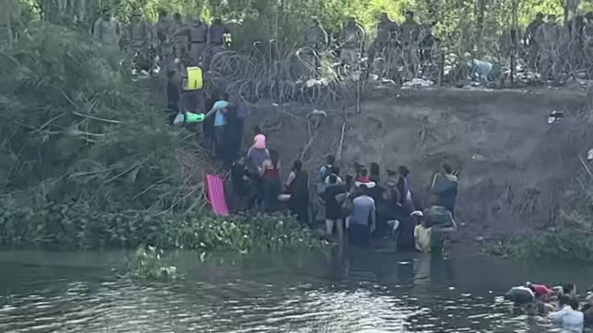 Texas National Guard soldiers physically blocking migrants who are attempting to illegally cross the US-Mexico border in Brownsville, TX. Razor wires deployed