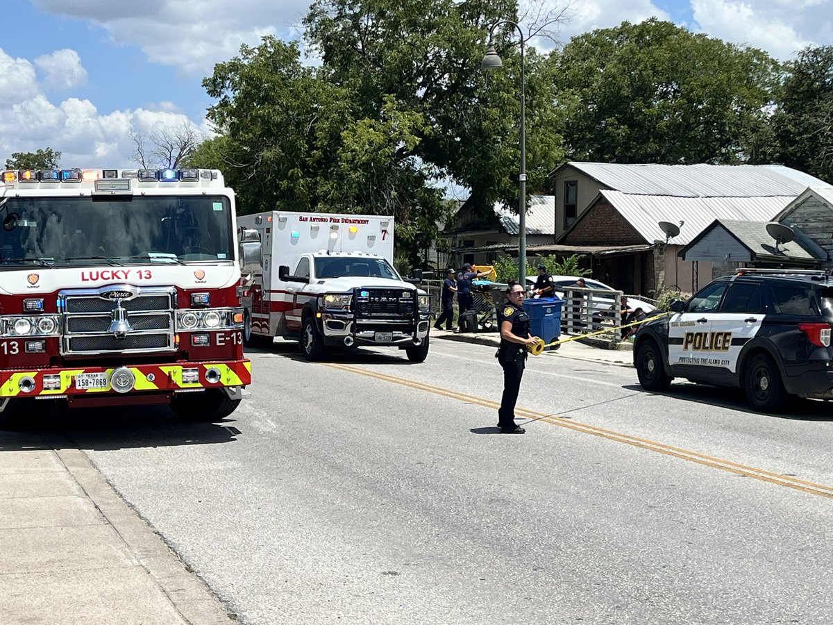 WOMAN SHOT: scene of a shooting.  person taken by ambulance and an adult male being detained by police.