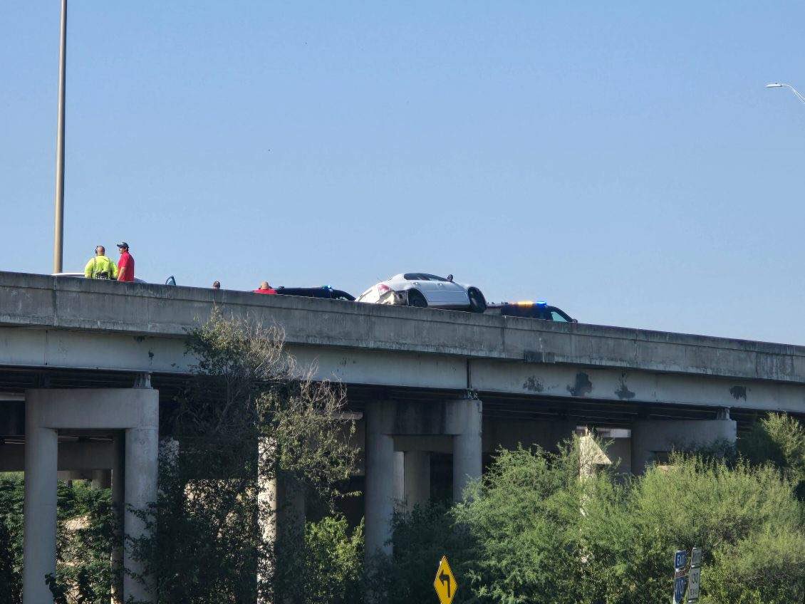 SA  pd along with Sa fire department are at a scene where a single vehicle is hinging from the side of a bridge. A tow truck is there to pull the car to safety. This at moursund rd and hwy 410. A lot of traffic. Avoid the area