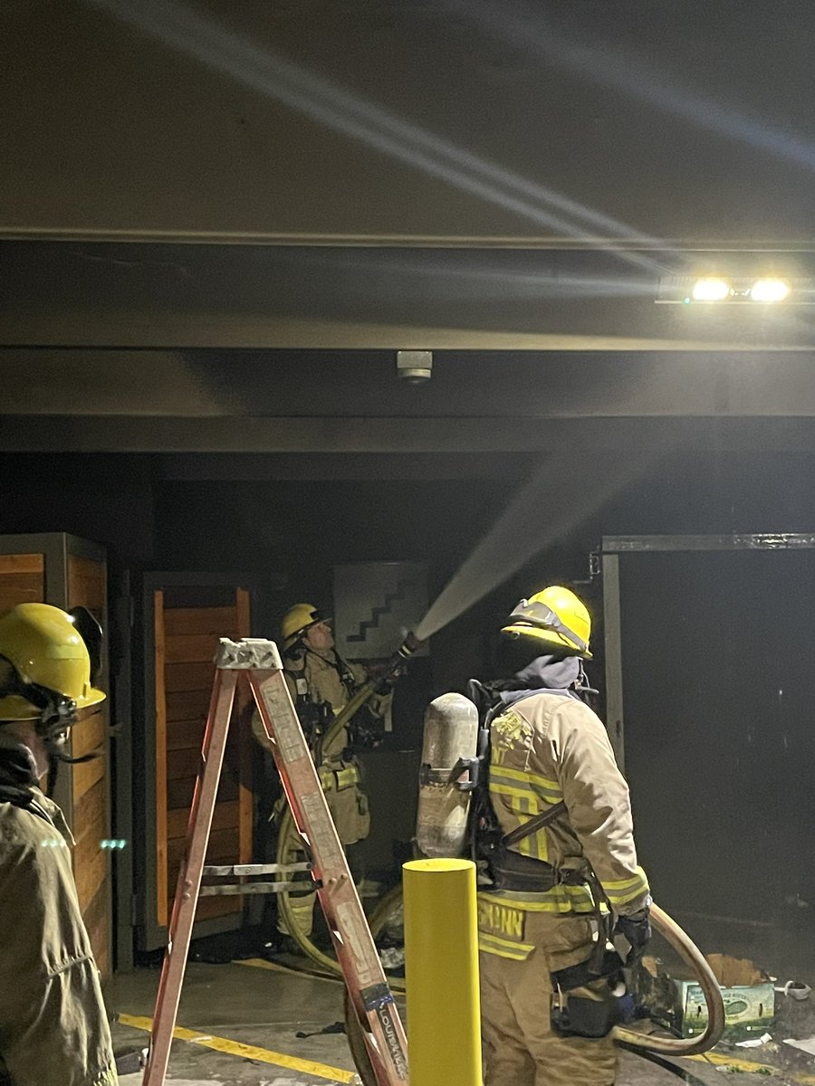 Austin firefighters on scene of a fire involving multiple dumpsters with fire extension unit the trash chute of an apartment building. Fire is now out, crews searching for additional fire and hazards