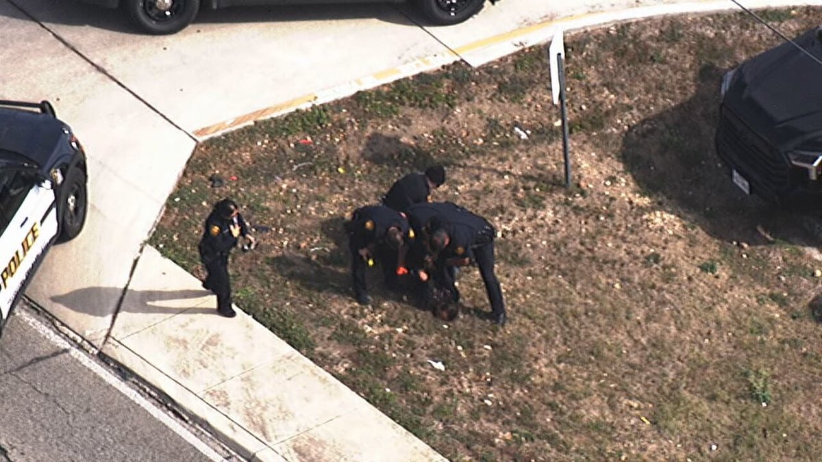Police officers were seen taking down a person after calls for a bomb threat near KENS-TV