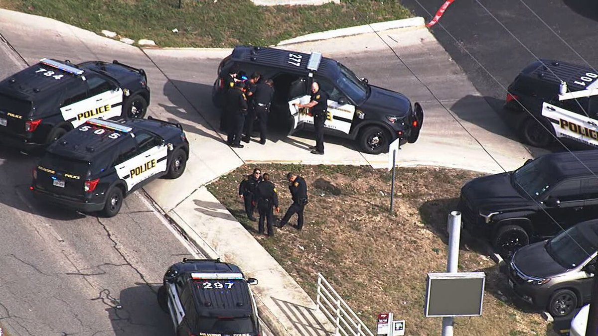 Police officers were seen taking down a person after calls for a bomb threat near KENS-TV