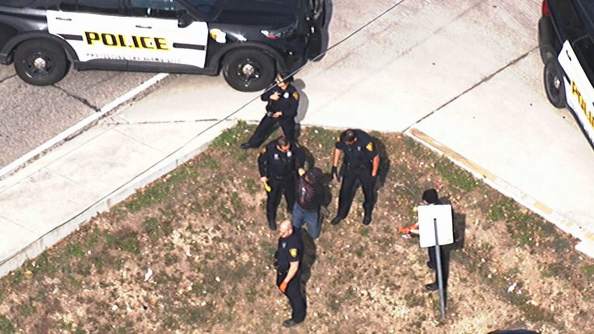 Police officers were seen taking down a person after calls for a bomb threat near KENS-TV