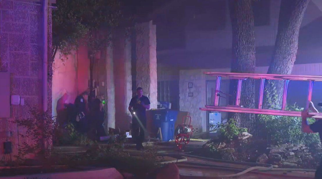 Firefighters contained a house fire Wednesday night after flames spread from an RV parked between two homes on the city’s Northwest Side, according to the San Antonio Fire Department