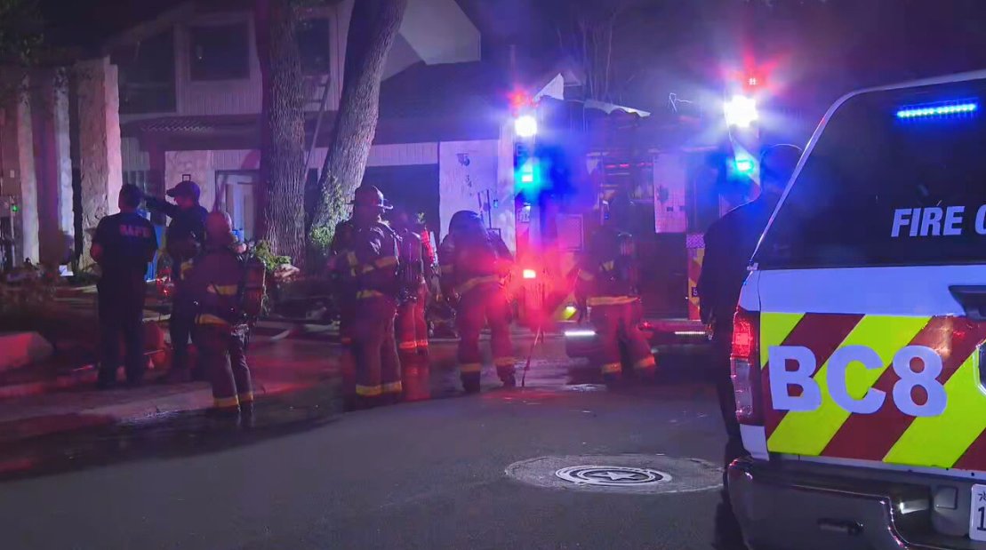 Firefighters contained a house fire Wednesday night after flames spread from an RV parked between two homes on the city’s Northwest Side, according to the San Antonio Fire Department