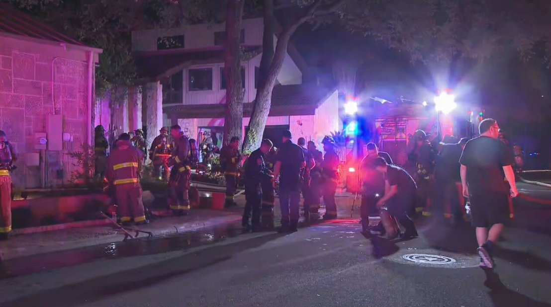 Firefighters contained a house fire Wednesday night after flames spread from an RV parked between two homes on the city’s Northwest Side, according to the San Antonio Fire Department