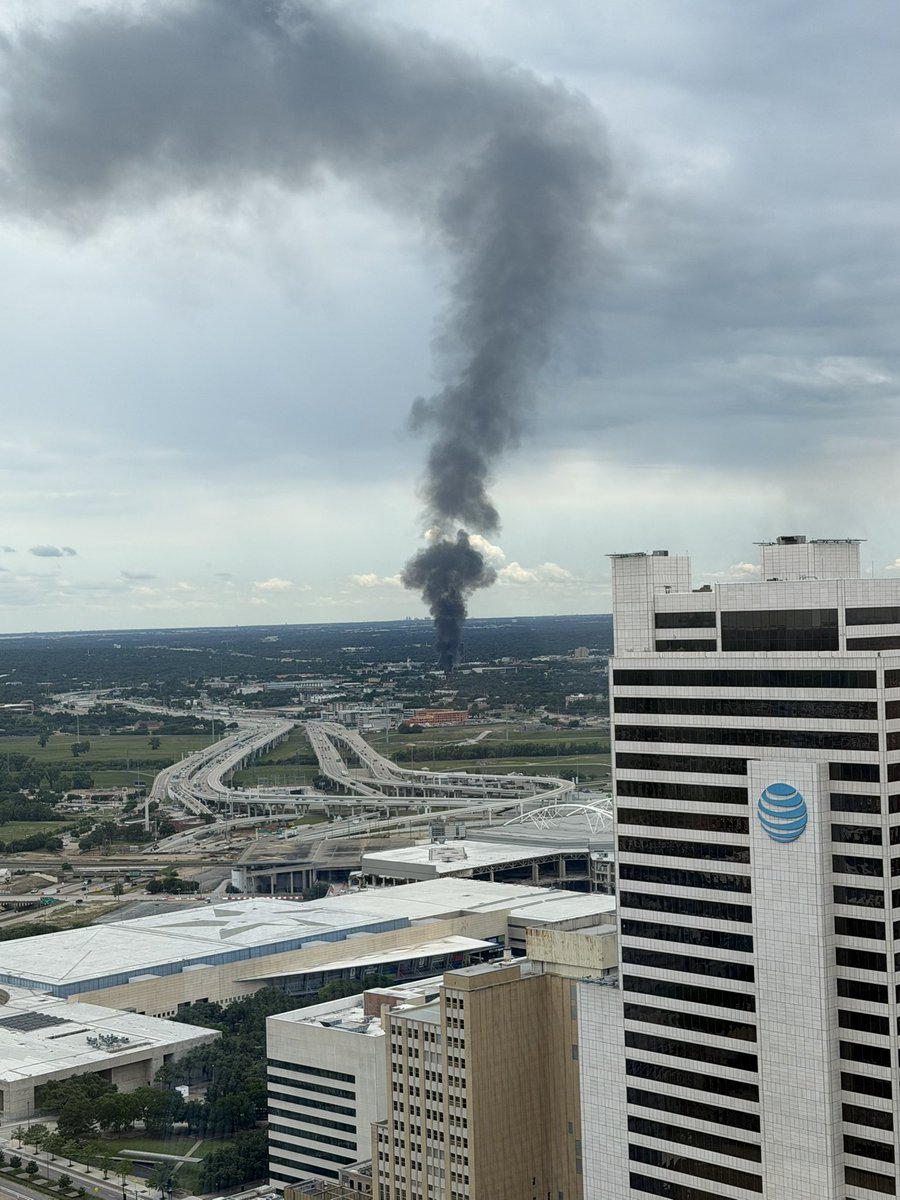 Large fire in the Oak Cliff neighborhood of Dallas, with flames—not just smoke, but flames—visible from miles away in downtown Dallas. Fire appears just west of I-35. Here’s the view from the 42nd floor of the Comerica Bank Tower